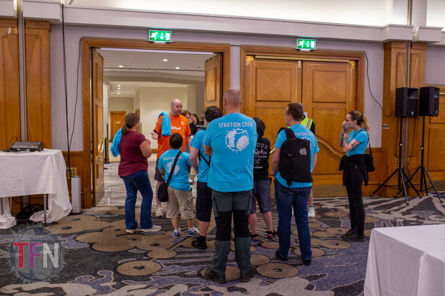 Numerous TFNation volunteers taking part is a briefing in the trader hall ahead of the event starting