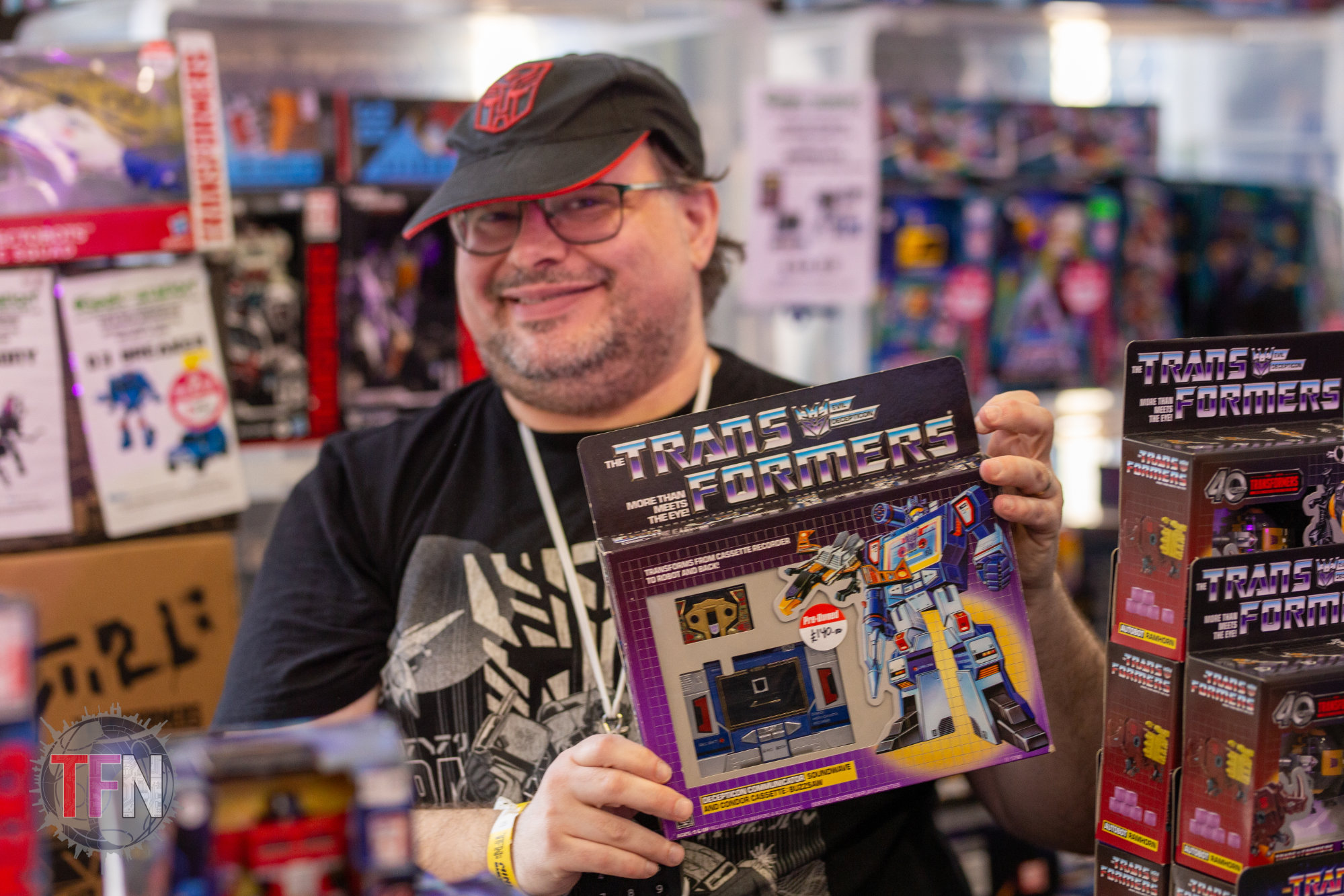 A trader holding a boxed G1 Soundwave at one of our events